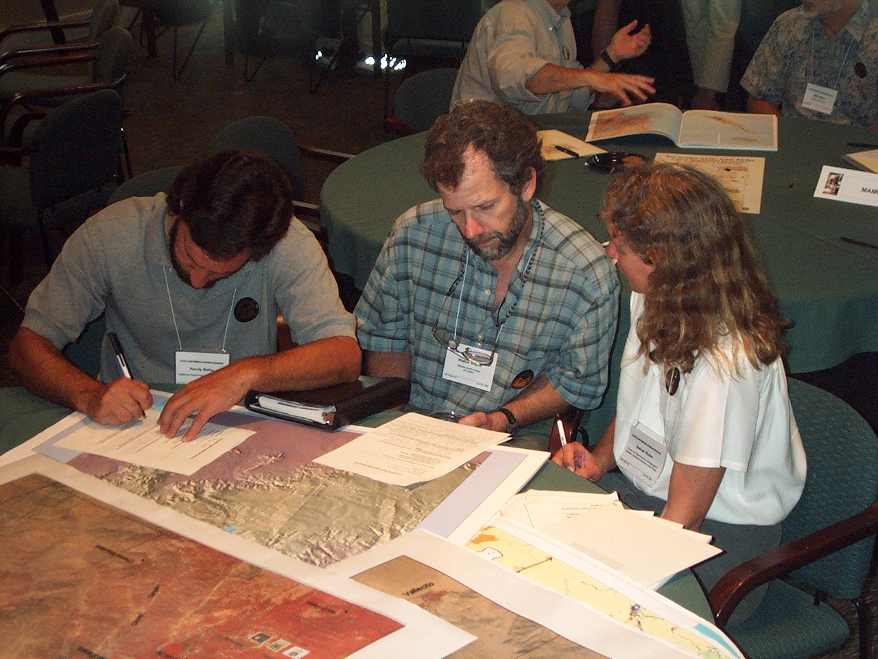 People with name tags reviewing a map together.